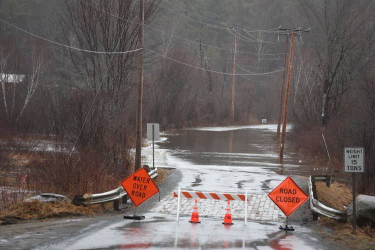 A section of Potato Road is closed to traffic due to water covering the roadway on Monday, March 17, 2025, in Canaan, N.H.   (Valley News-Jennifer Hauck)