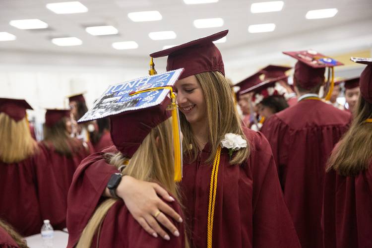 Megan Bell, right, hugs Delaney Deshane before their graduation ceremony at Lebanon High School in Lebanon, N.H., on Thursday, June 8, 2023. (Valley News / Report For America - Alex Driehaus) Copyright Valley News. May not be reprinted or used online without permission. Send requests to permission@vnews.com.