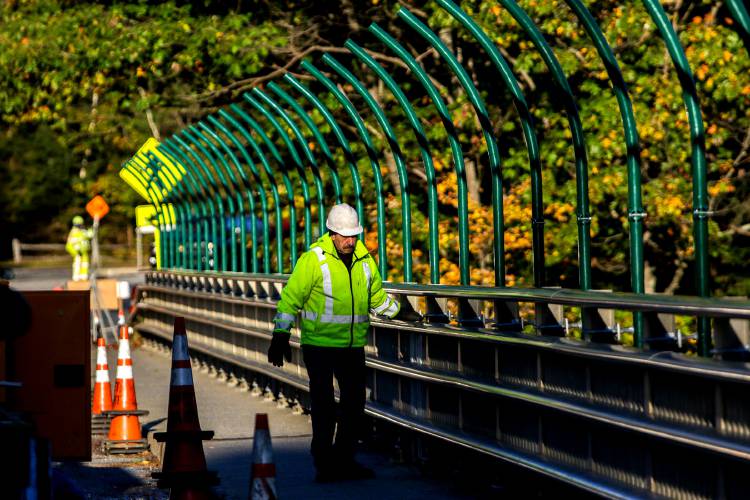 Bill Frye, of Barnet, Vt., works on installation of a fence over the Quechee Gorge that will seek to prevent suicides in Quechee, Vt., on Tuesday, Oct. 16, 2018. Construction began on Monday and is expected to take around 30 days, with work taking place from 7:00 a.m. to 4:30 p.m. After putting up poles on both sides, the crew will begin installation of a chain link fence on the poles. (Valley News - August Frank) Copyright Valley News. May not be reprinted or used online without permission. Send requests to permission@vnews.com.