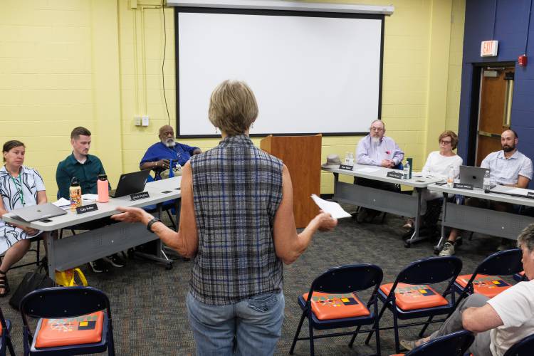 Sadie Woods, of West Hartford, center, questions the Hartford School Board during a special meeting in White River Junction, Vt., on Thursday, July 18, 2024, about its decision to pay former Superintendent Tom DeBalsi a full year's salary following his retirement. DeBalsi retired one year before the end of his contract and will receive $210,214.65 from the district through June, 2025. (Valley News - James M. Patterson) Copyright Valley News. May not be reprinted or used online without permission. Send requests to permission@vnews.com.